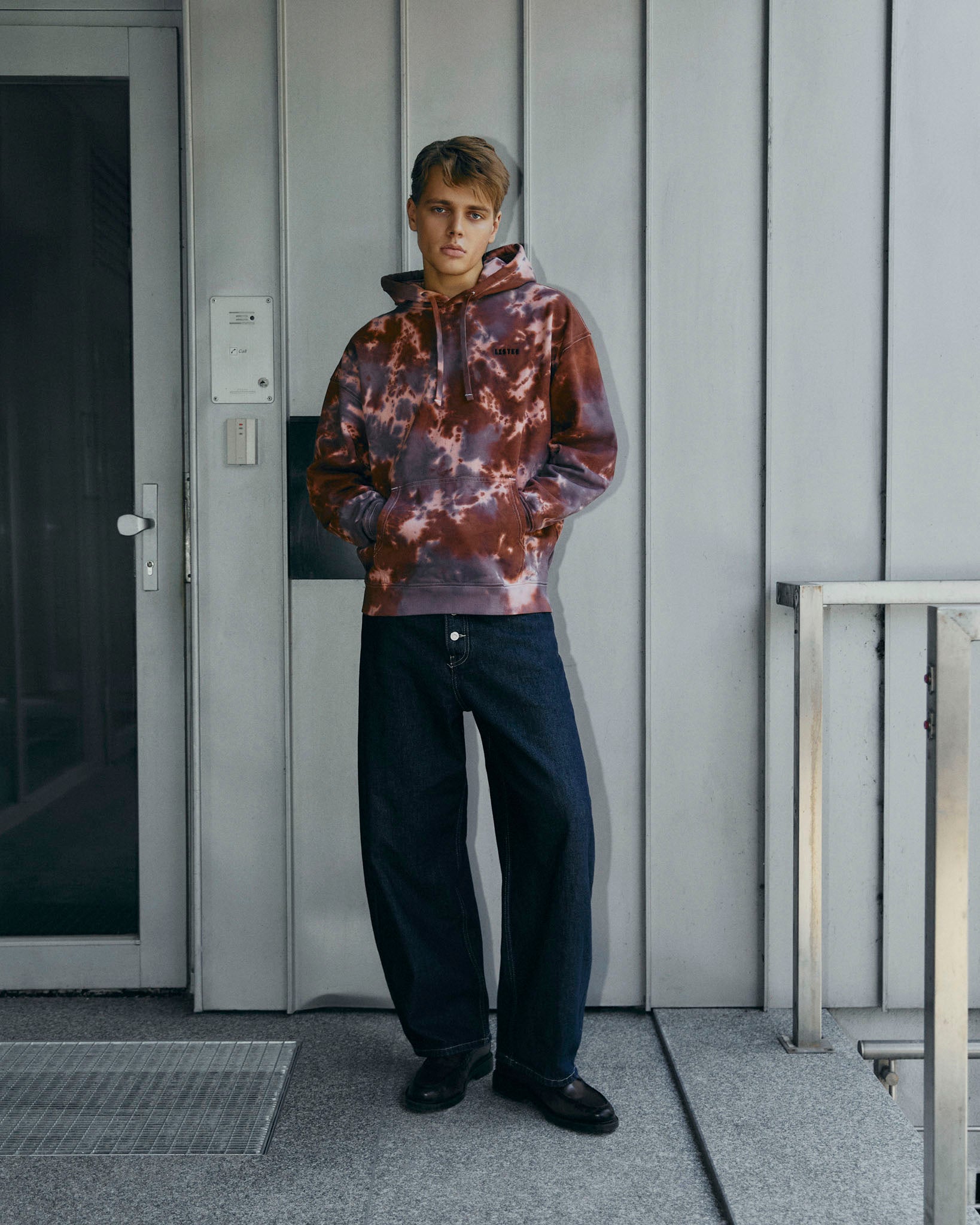 A tie-dye pullover hoodie with a brown, grey, and white marbled pattern, featuring a small black 'LISTEE' logo on the left chest, displayed against a solid off-white background.