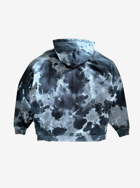 A hoodie with a dark gray and black tie-dye pattern, shown from the back against a light gray background.