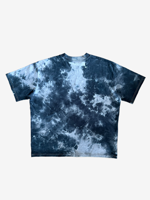 A short-sleeve oversized crewneck t-shirt featuring a black and grey tie-dye pattern, laid flat against a light gray background.