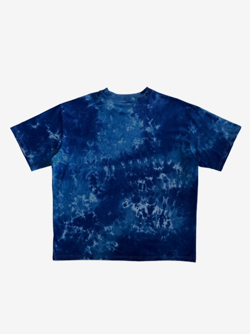 A short-sleeve crewneck t-shirt featuring a blue and navy blue tie-dye pattern, displayed flat against a light gray background.