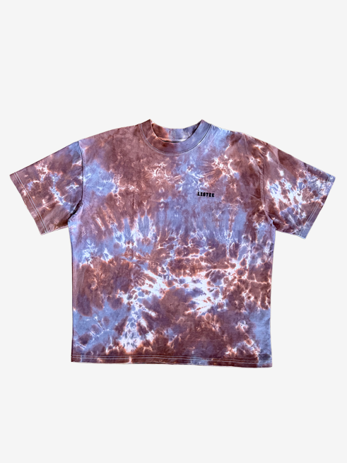 A short-sleeve crewneck t-shirt featuring a brown and grey tie-dye pattern, with a small black 'LISTEE' text logo printed on the left chest, displayed flat against a light gray background.